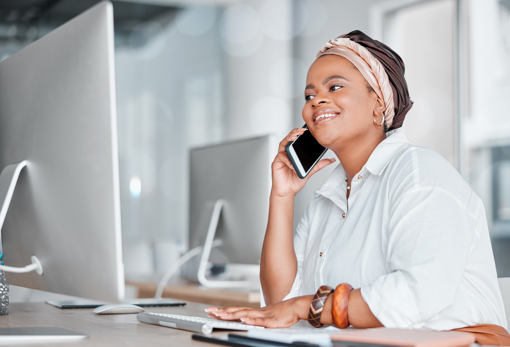 Communication, conversation and black woman on a phone call while working on a computer. Contact, c