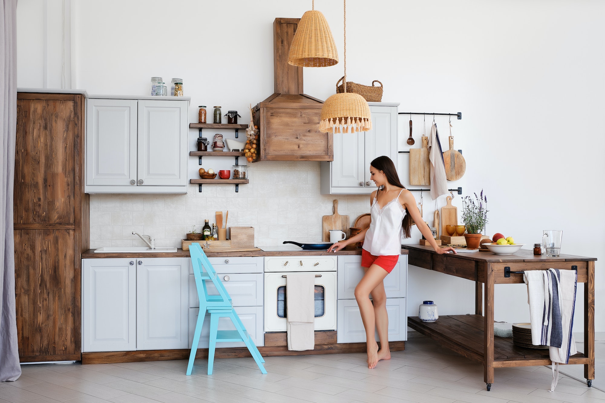 cute girl standing by the stove in the kitchen